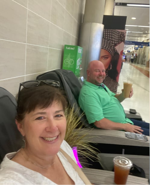 Diane and David testing massage chairs at the airport