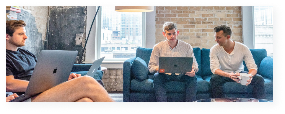 Group of people on couches looking at their laptops. 